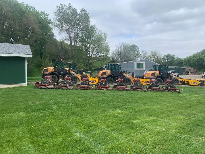 Lineup of commercial mowing machines and equipment on grass
