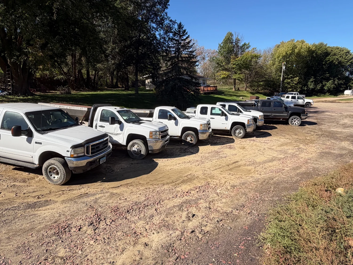GreenSpace fleet of trucks parked along a driveway